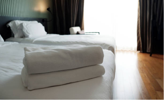 Why do high-end hotels prefer the substantial feel of a blanket?