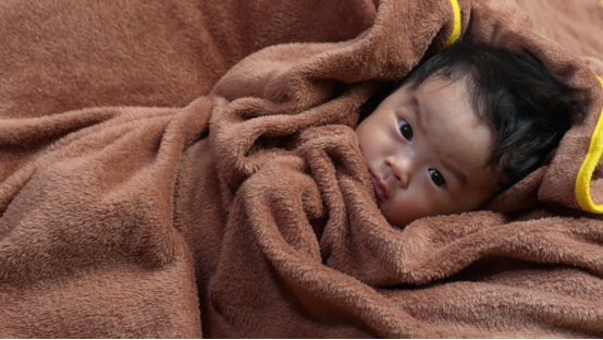 A blanket is a convenient tool for new parents.