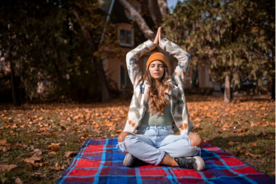 Yoga practitioner using a blanket for extra comfort during morning practice