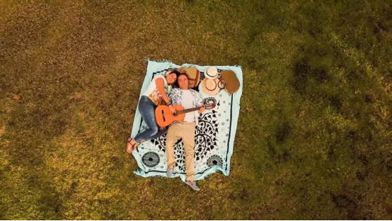 A brightly patterned blanket at a music festival, defining personal space
